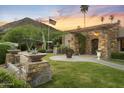 Inviting property featuring manicured lawn, a stone facade and walkway leading to the main entrance at 4836 E Moonlight Way, Paradise Valley, AZ 85253
