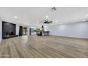 Spacious open-concept living room with wood flooring, fireplace, and modern kitchen at 5728 E Sharon Dr, Scottsdale, AZ 85254