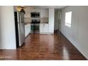 Updated kitchen with white cabinets, stainless appliances, and wood-look flooring at 61 W Southern Ave # 31, Mesa, AZ 85210