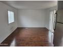 Spacious living room with wood-look floors, ample light, and a sliding glass door at 61 W Southern Ave # 31, Mesa, AZ 85210