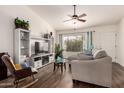 Cozy living room with a ceiling fan, entertainment center, and comfortable seating arrangement at 6160 S Pebble Beach Dr, Chandler, AZ 85249