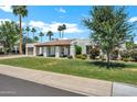 Charming single-story home featuring a well-manicured lawn and desert landscaping at 8034 E Del Caverna Dr, Scottsdale, AZ 85258