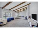 Bright living room with a vaulted ceiling, beams, and plush seating at 8034 E Del Caverna Dr, Scottsdale, AZ 85258