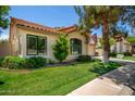 Lovely single-story home with a well-kept lawn, mature trees, and a tiled roof, offering curb appeal at 9575 S Ash Ave, Tempe, AZ 85284