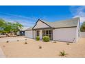 Inviting single-story home with a well-kept lawn and a comfortable front porch at 9855 S 47Th Pl, Phoenix, AZ 85044
