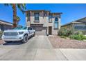 Exterior of home with desert landscaping, a spacious driveway, and an attached two-car garage at 9934 E Empress Ave, Mesa, AZ 85208