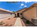 A well-maintained home entrance with desert landscaping, providing a welcoming curb appeal at 11139 W Devonshire Ave, Phoenix, AZ 85037