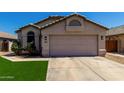 Attractive single-level home features a two-car garage, desert landscaping, and a cozy entryway at 15231 W Melissa Ln, Surprise, AZ 85374