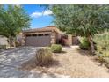 Charming single-story home featuring a two-car garage, desert landscaping, and a beautiful blue sky at 154 W Hayden Park Rd, San Tan Valley, AZ 85143