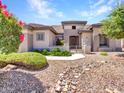Stunning home exterior featuring desert landscaping and a welcoming entrance at 15539 W La Salinas Ln, Surprise, AZ 85374