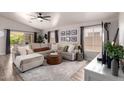 Bright living room featuring a large sectional sofa, modern decor, and large windows for ample natural light at 1707 W Stanford Ave, Gilbert, AZ 85233