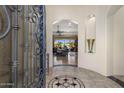 Elegant foyer with arched entrance and decorative tile inlay, leading to an open living space at 18036 W San Miguel Ave, Litchfield Park, AZ 85340