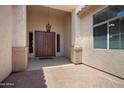 Covered front entrance with double doors, sidelights, and a charming outdoor chandelier at 18242 W Stinson Dr, Surprise, AZ 85374