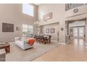 Bright living room featuring a dining area, high ceilings, carpeted floor and a modern chandelier at 19427 W Colter St, Litchfield Park, AZ 85340