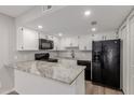 Updated kitchen featuring granite countertops, modern appliances, and white cabinets at 2144 E Center Ln # 3, Tempe, AZ 85281