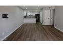 Open-concept living area showcases wood flooring, and seamlessly connects to the updated kitchen at 2144 E Center Ln # 3, Tempe, AZ 85281