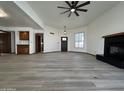 Spacious living room boasting wood-look tile floors, a ceiling fan, and a fireplace at 2169 E Bishop Dr, Tempe, AZ 85282