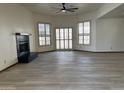 Bright living room with a fireplace, wood-look floors, and natural light from several windows at 2169 E Bishop Dr, Tempe, AZ 85282