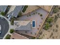 Aerial view of the backyard, home and neighborhood shows landscaping and layout at 21797 N 259Th Ave, Buckeye, AZ 85396