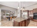 Gourmet kitchen featuring granite countertops, stainless steel appliances, and an open layout to living room at 2255 N Hillridge --, Mesa, AZ 85207