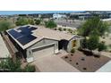 A charming single-story home with solar panels, a two-car garage, desert landscaping, and a brick-paved driveway at 31324 N 26 Glen Gln, Phoenix, AZ 85085
