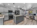Open-concept kitchen with modern appliances, granite countertops, and an island open to living area at 3373 W Five Mile Peak Dr, San Tan Valley, AZ 85144