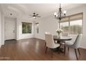 Bright dining room with a chandelier, ample natural light, wood floors, and stylish furnishings at 3438 W Little Hopi Dr, Phoenix, AZ 85086