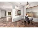 Inviting dining room with stylish chandelier and a marble-topped table, next to open floor plan at 3438 W Little Hopi Dr, Phoenix, AZ 85086