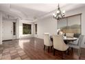 Bright dining room with a chandelier, ample natural light, wood floors, and stylish furnishings at 3438 W Little Hopi Dr, Phoenix, AZ 85086