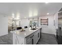 Renovated kitchen with quartz countertops, stainless steel appliances and view of the dining room at 3850 E Ludlow Dr, Phoenix, AZ 85032