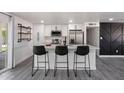 Bright kitchen features stainless steel appliances, quartz countertops, and bar stool seating at 3850 E Ludlow Dr, Phoenix, AZ 85032