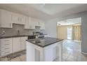 Modern kitchen featuring an island, sleek appliances, and easy access to a bright dining area at 4025 E Surrey Ave, Phoenix, AZ 85032