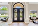 Elegant foyer with decorative wood floors, double entry doors, decorative columns, and an arched transom at 4040 E Mclellan Rd # 16, Mesa, AZ 85205