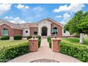 Charming front entrance featuring a brick pathway, manicured landscaping, a decorative door with sidelights, and exterior lanterns at 4040 E Mclellan Rd # 16, Mesa, AZ 85205