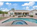 Backyard pool and spa with a fence, patio, and covered porch on the exterior of the home at 4040 E Mclellan Rd # 16, Mesa, AZ 85205