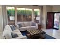 Bright living room with large windows and modern decor, creating a cozy atmosphere at 41318 N Belfair Way, Anthem, AZ 85086