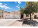 Inviting two-story home with a three car garage, landscaping, and a welcoming entrance at 43525 W Cydnee Dr, Maricopa, AZ 85138