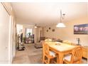 Open concept living area with dining table and chairs at 455 S Mesa Dr # 104, Mesa, AZ 85210