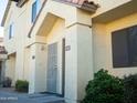 Exterior view of townhouse shows stucco, red tile roof, and unit numbers 103 and 104 at 455 S Mesa Dr # 104, Mesa, AZ 85210