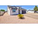 Charming home with a well-maintained yard, attractive landscaping, and a two car garage at 461 W Lindbergh Ave, Coolidge, AZ 85128