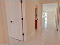 Bright hallway with white doors, neutral paint and tile floor at 461 W Lindbergh Ave, Coolidge, AZ 85128