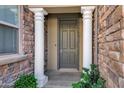 Inviting entryway features a gray front door flanked by white columns and stone accents at 4777 S Fulton Ranch Blvd # 2071, Chandler, AZ 85248