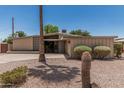 Mid-century home with a well maintained desert landscape at 5420 N Granite Reef Rd, Scottsdale, AZ 85250