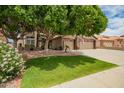 Charming two-story home with a well-manicured lawn, mature tree and a three car garage at 6862 W Honeysuckle Dr, Peoria, AZ 85383