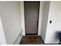 A welcoming, stylish front door enhances curb appeal and security with a modern digital lock at 6947 W Spur Dr, Peoria, AZ 85383