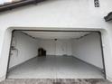 Spacious two-car garage with a clean epoxy floor, offering ample storage and parking space at 6947 W Spur Dr, Peoria, AZ 85383