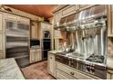 Gourmet kitchen with stainless steel appliances, custom cabinetry, and a professional range at 7710 E Golden Eagle Cir, Gold Canyon, AZ 85118