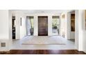 Spacious foyer featuring a modern front door, stylish rug, and ample natural light at 9894 E Miramonte Dr, Scottsdale, AZ 85262