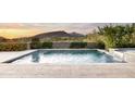 Beautiful pool with mountain views and desert landscaping, perfect for relaxing and enjoying the outdoors at 9894 E Miramonte Dr, Scottsdale, AZ 85262