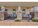 Cozy front porch with stone pillars, seating, and a brick pathway at 1500 E Sagittarius Pl, Chandler, AZ 85249